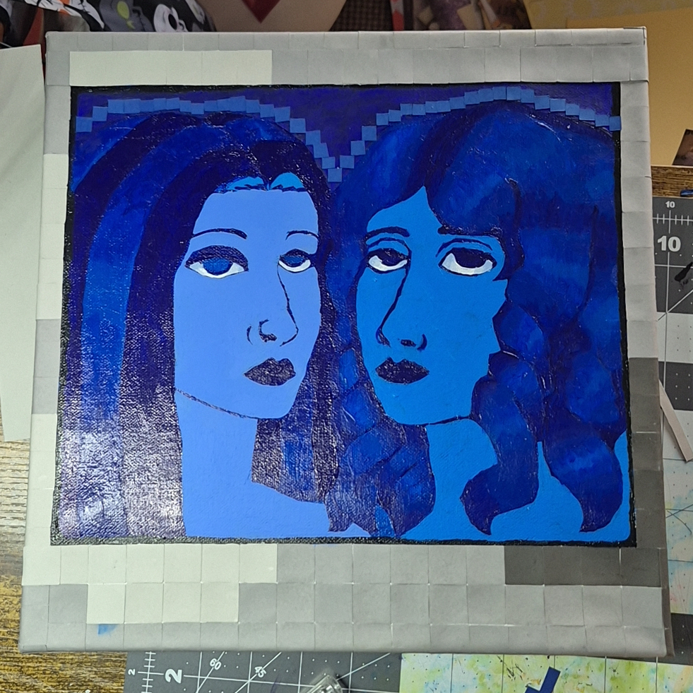 Picture of a painting and collage piece of two people in blue.